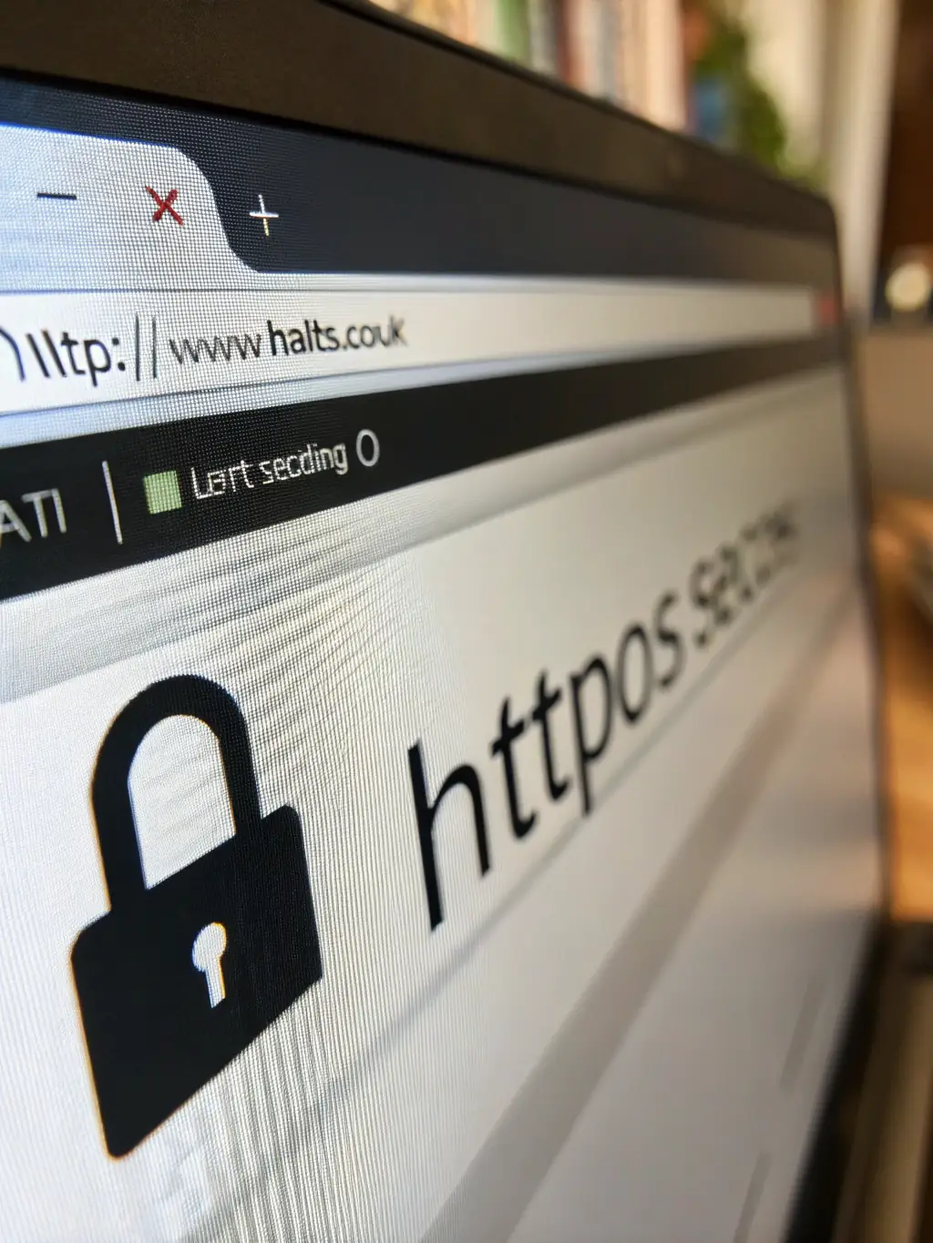 A laptop displaying a website with a secure padlock icon, representing secure hosting and regular maintenance.